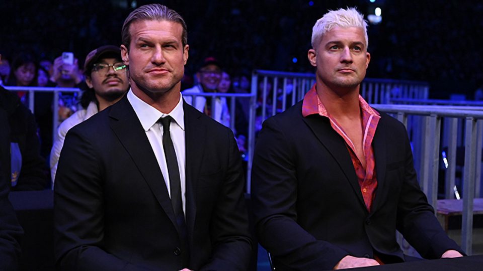 Dolph Ziggler and Ryan Nemeth sitting at ringside at NJPW Wrestle Kingdom 18