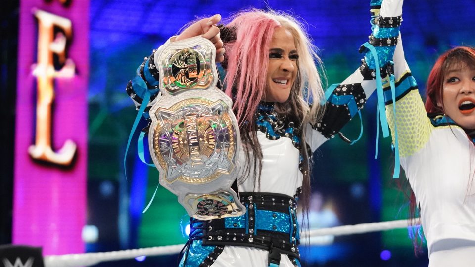 Dakota Kai celebrating in the ring with a Women's Tag Team Championship title at WWE Crown Jewel 2022